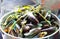 Mussels steamed with vegetables in a stainless steel pot.