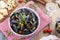 mussels in a white ceramic bowl, on a red napkin. Cheese on a wooden board and a glass of white wine, olives, bread. Meat on a