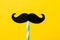 Mustache of paper on yellow background