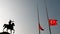 Mustafa Kemal Ataturk riding horse sculpture silhouette and lower Turkish flags
