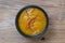 Mustard dip with chili threads macro on wood background and top