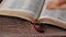 Mustard seeds spilled on open Holy Bible Book with wood background, faith in God Jesus Christ