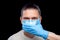Mute male portrait doctor in medical mask and surgical glove cover mouth.