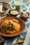 Mutton Kacchi biryani with salad, borhani and Chui Pitha served in dish isolated on mat top view of indian and bangladeshi food