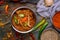 Mutton rogan josh indian food in copper on blue wooden table top view