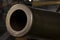 Muzzle of a large-caliber cannon with a rifled barrel from the Second World War, close-up.