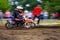 MX rider turns in a dirt. Motion blur with flying dirt