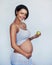 My baby deserves the healthiest start in life. Studio shot of an attractive young pregnant woman holding a green apple.