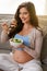 My baby loves it when I eat organic food. a pregnant woman eating a healthy salad at home.