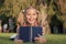 My education came from encyclopedia. Happy little girl read encyclopedia on green grass. Adorable small child smile with