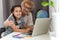 This is my favourite movie. Shot of an adorable little girl using a laptop while sitting at home with her grandmother.