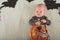 My first Halloween. Small child and pumpkin. Autumn concept, halloween, bats, pumpkins, newborn close-up and copy space