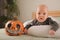 My first Halloween. Small child and pumpkin. Autumn concept, halloween, bats, pumpkins, newborn close-up and copy space