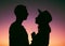 My heart is yours. an affectionate young couple silhouetted at sunset.