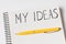 MY IDEAS inscription in notepad. Close up, pen on notebook