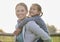 My little girl, the love of my life. an adorable little girl enjoying a piggyback ride with her mother on her farm.