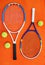 These are my tools. High angle shot of tennis essentials placed on top of an orange background inside of a studio.