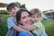 These are my two treasures. Portrait of a mother bonding with her two little children outdoors.