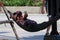 Myanmar lady with Thanaka powder resting in hammock at Pattaya Thailand