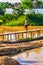 Myanmar rural farmer person walking over bamboo river bridge