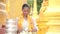 Myanmar women holding flowers at a temple. Southeast Asian young girls with burmese traditional dress visiting a Buddihist temple.