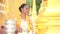 Myanmar women holding flowers at a temple. Southeast Asian young girls with burmese traditional dress visiting a Buddihist temple.