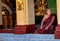 Myanmar, Yangon, November 2019, Shwedagon Pagoda, elderly male Buddhist monks with shaved heads are sitting at the pagoda