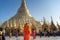 Myanmar, Yangon, November 2019, Shwedagon Pagoda, a male Buddhist monk with shaved heads stands in front of the central pagoda