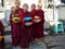 Myanmese Buddhist novices waiting to recive food or other things with alms bowls.