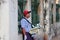 Myanmese male street vendor selling betel quids, it is a areca nuts, lime and tobacco wrapped in a betel leaf for chew, beside the