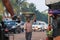 Myanmese woman with thanakha Myanmar powder on her face put big aluminum enameled basin on her head to bring the products to the