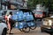 Myanmese worker man pushing the three wheel of water tanker barrow on the street at Yangon