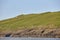 Mykines lighthouse and cliffs on Faroe islands. Green rocky hills