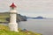 Mykines lighthouse and cliffs on Faroe islands. Hiking landmark