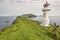 Mykines lighthouse and cliffs on Faroe islands. Hiking landmark