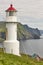 Mykines lighthouse and cliffs on Faroe islands. Hiking landmark