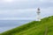 Mykines lighthouse and cliffs on Faroe islands. Hiking landmark. Denmark