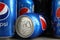 MYKOLAIV, UKRAINE - FEBRUARY 9, 2021: Many cans of Pepsi on grey table, closeup