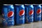 MYKOLAIV, UKRAINE - FEBRUARY 9, 2021: Many cans of Pepsi on table against black background