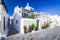 Mykonos, Greece - Cobblestone alley whitewashed village Cyclades Islands
