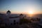 Mykonos, Greece. Sunset over the sea with iconic windmills of the Greek island of the Mikonos, seen from terrace