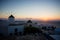 Mykonos, Greece. Sunset over the sea with iconic windmills of the Greek island of the Mikonos, seen from terrace