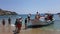 Mykonos, Greece - Tourists embarking in a water taxi at Paradise beach.