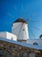 Mykonos, Greece. Traditional windmills. The symbol of Mykonos at the day time. Landscape with traditional windmils.