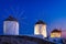 Mykonos, Greece. Traditional windmills. The symbol of Mykonos during  sunset. Landscape during sunset. Sea shore and beach.