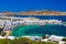 Mykonos port with boats and windmills at evening, Cyclades islands.