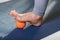 Myofascial relaxation of hyper-movable muscles of the foot, with a massage ball on a gymnastic mat, close-up