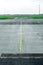 Myst on empty airport runway tarmac with directional and markings sign