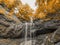 A mysterious autumn waterfall hidden in a remote forest