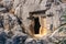 Mysterious dark entrance to an ancient stone tomb, carved into the rock, in Myra Lycian now Demre, Turkey